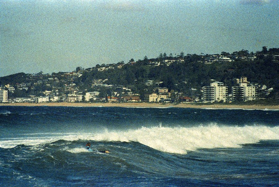 Серфер, едущий по волне на пляже North Narrabeen Beach